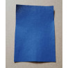 Iron-on  repair fabric in a royal blue color, placed on a beige background