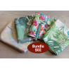 Outdoor fabric remnants bundle - mix of tropical patterns, placed on a wooden table