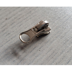 zip slider- chunky- size 3 - silver - short puller, plac3ed on a wooden table