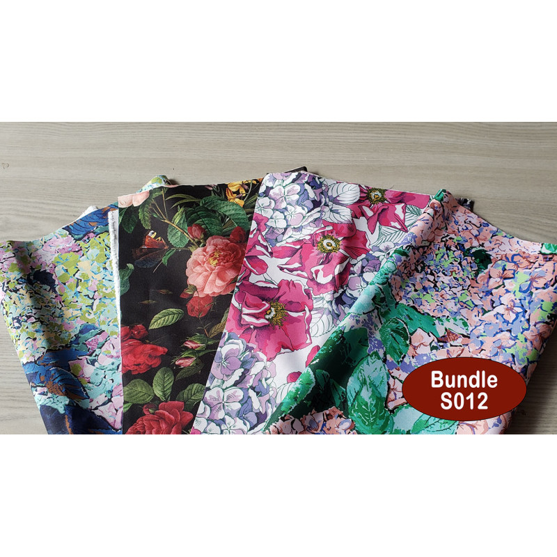 Outdoor fabric remnants bundle - floral designs, four pieces of fabric placed on a white wooden background