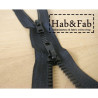 double slider chunky zip - black - 95cm placed on a wooden background