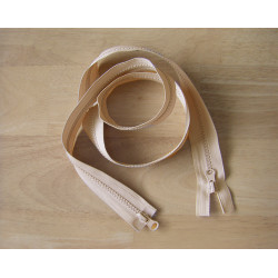 double slider chunky zip - beige 
 color, 85cm long, twisted on the wooden background
