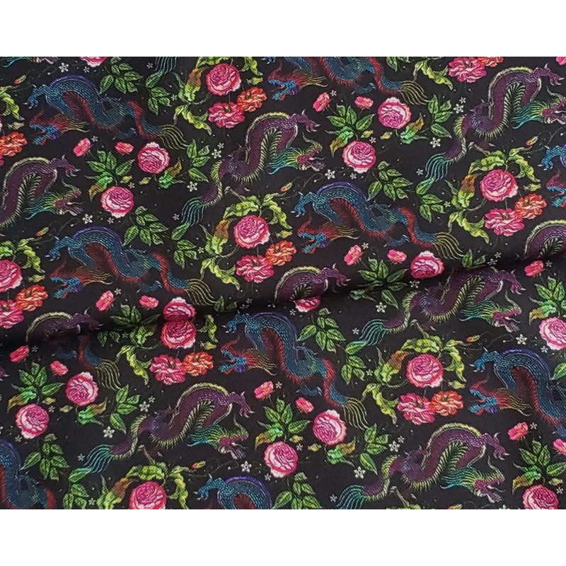 Water-resistant canvas fabric - Mini Dragons&Roses on black placed across the frame with a fold