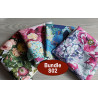 Outdoor fabric remnants bundle - mix of floral patterns, placed on a wooden table