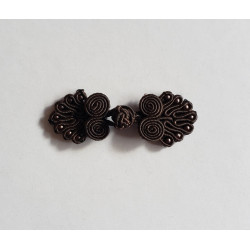 Frog fastener- dark brown with beads, placed on a white background