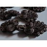 set of dark brown frog fasteners placed on a white background